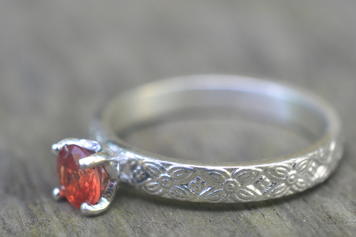 Carved Floral Poesy Ring in Silver With Orange Sapphire