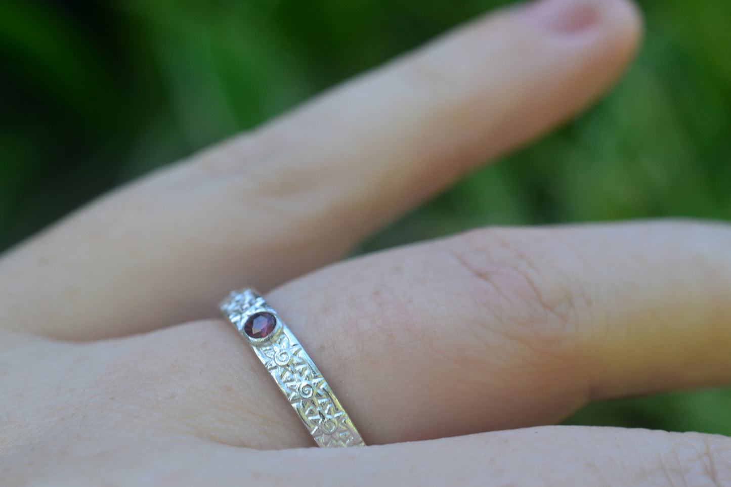 Silver Sun Wedding Band With Tiny Garnet